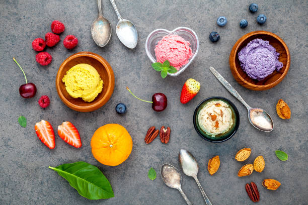 istock Flat lay ice cream with various fruits raspberry ,blueberry ,strawberry ,orange and cherry  setup on dark stone background . Summer and Sweet menu concept. 843000444