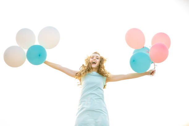 istock beautiful woman with flying multicolored balloons 843000558