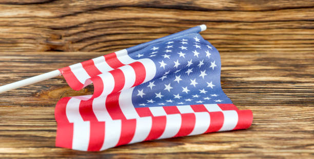 istock Small American flag on wooden background. Close up. 843001790