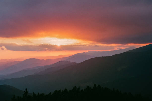istock Mountain hill with stormy sky and sunbeam at sunset 843005132