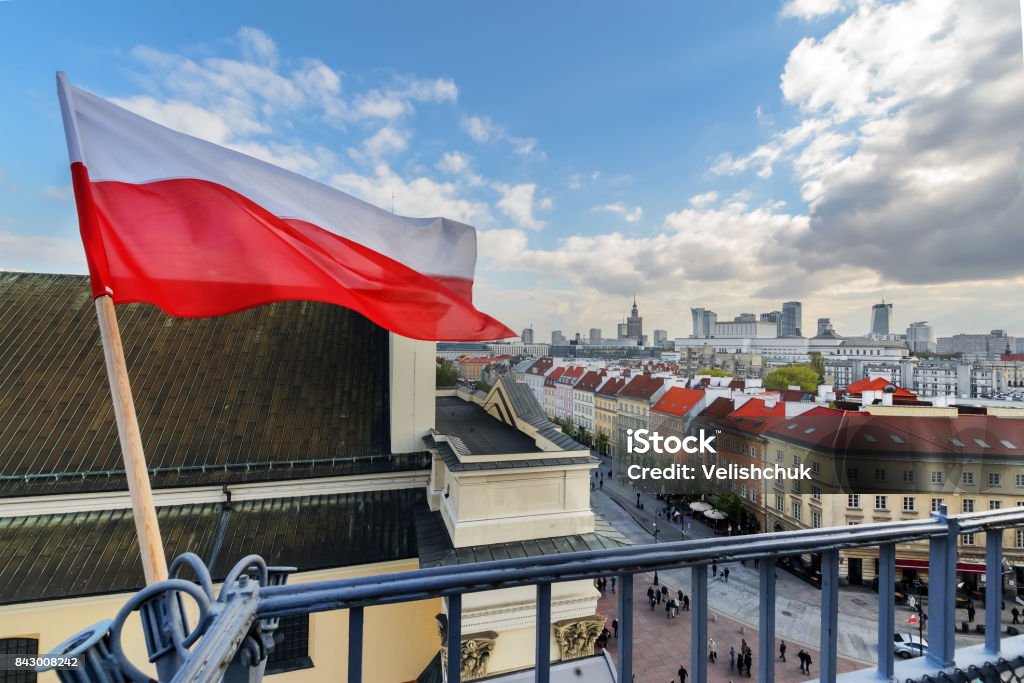 Poland Flag in Blue Sky and Warsaw in background Poland Flag in Blue Sky and the centre of Warsaw in background Poland Stock Photo