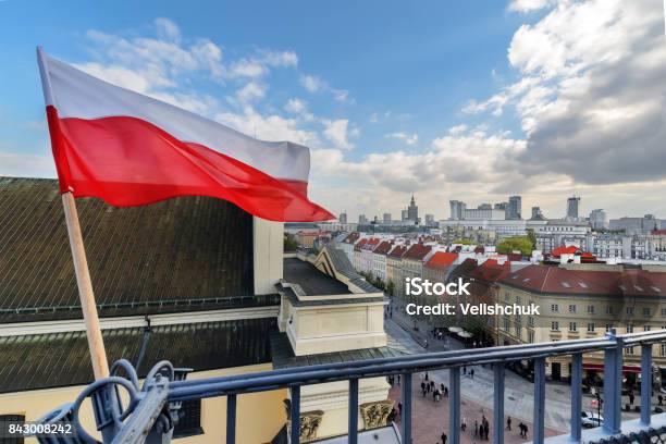 Poland Flag In Blue Sky And Warsaw In Background Stock Photo - Download Image Now - Poland, Flag, Warsaw