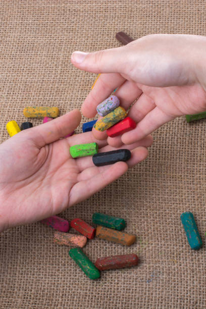 istock Used  color crayons and a teenagers hands 843009350