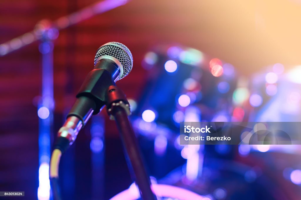 Microphone at concert Microphone at concert on the stage with colorful light Musical Instrument Stock Photo