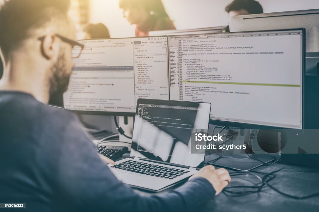 Website design. Developing programming and coding technologies. Developing programming and coding technologies. Website design. Programmer working in a software develop company office. IT Support Stock Photo