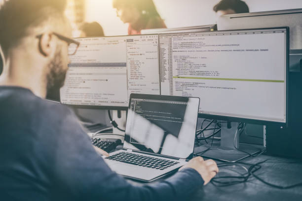 Website design. Developing programming and coding technologies. Developing programming and coding technologies. Website design. Programmer working in a software develop company office. application modernization stock pictures, royalty-free photos & images