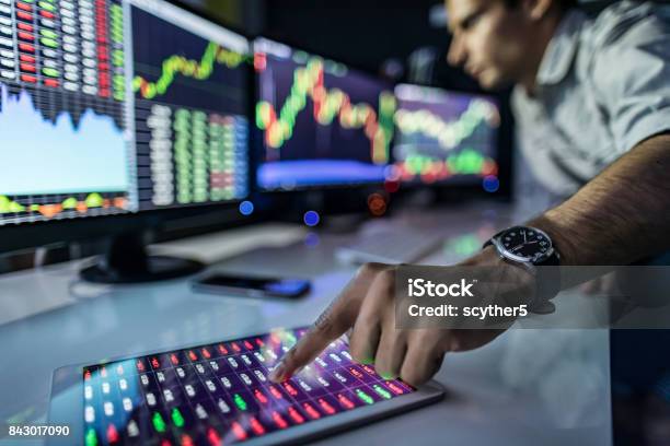 Analyzing Graphs And Reports For Investment Purposes Stock Photo - Download Image Now