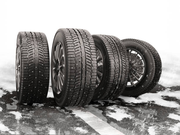 Four car tires rolling on a snow-covered road. Four car tires rolling on a snow-covered road. 3d illustration. metal stud stock pictures, royalty-free photos & images