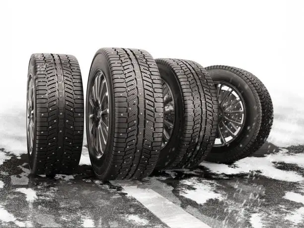 Four car tires rolling on a snow-covered road. 3d illustration.