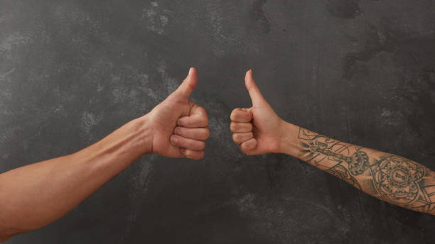 Hand of man and female hand with tattoo stock photo