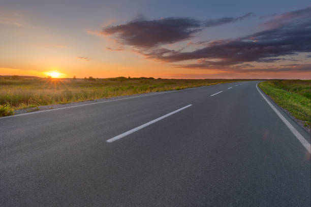 istock Curved asphalt road in plain at beautiful sunset 843028956