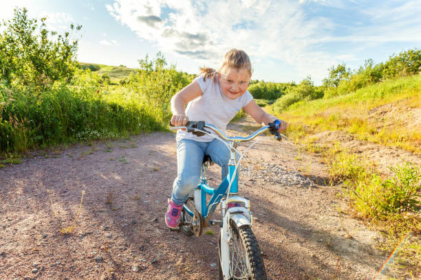 istock Smiling little girl on a bicycle 843030384