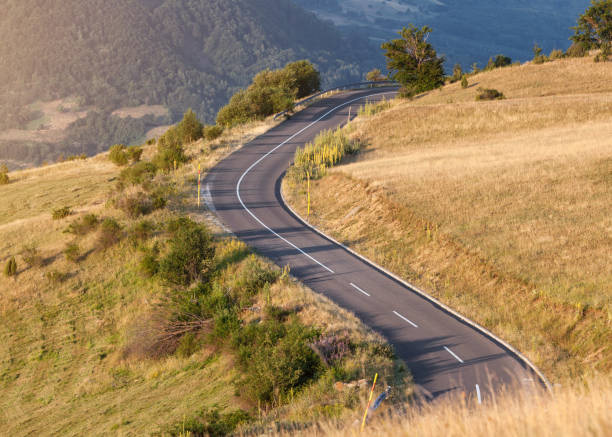 Winding mountain road at beautiful sunset