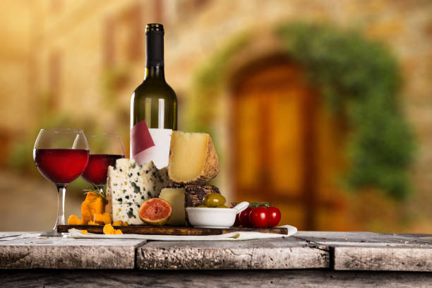 Various types of italian cheeses with red wine, still-life.