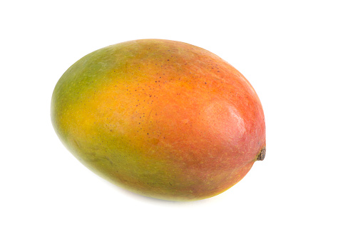 Single mango fruit on white background. Healthy food, whole and ripe mango with hints of green yellow, orange and red.