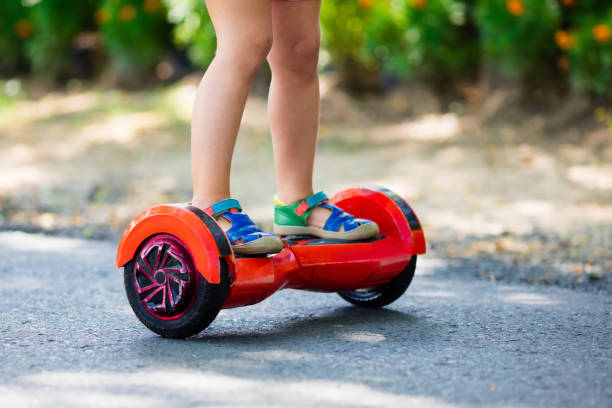 istock Child on hover board. Kids ride scooter. 843045378