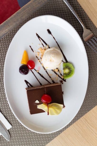 istock chocolate layer cake and vanilla ice cream with fresh fruit and cherry 843052546