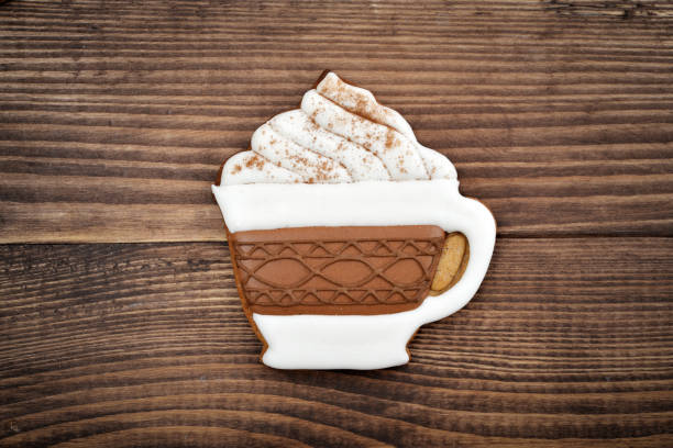 Christmas homemade gingerbread cookie in shape of coffee cup on wooden table