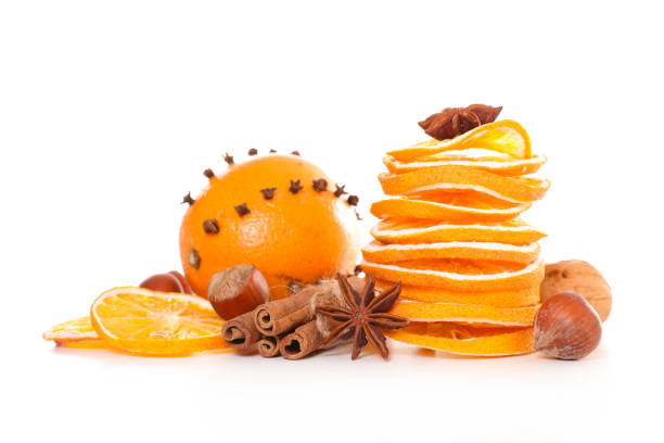dried orange and spices isolated on white