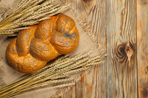 istock Wheat and traditional wicker Russian bread on a wooden background 843067052