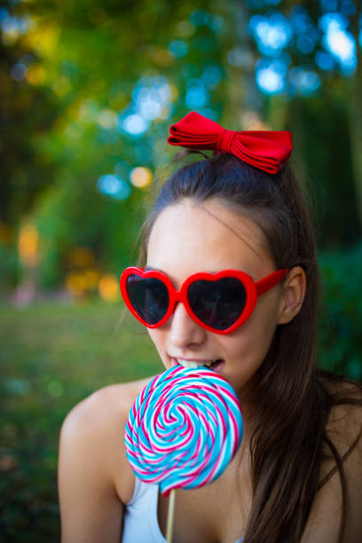 istock Cheerful young girl with candy on stick. 843071282