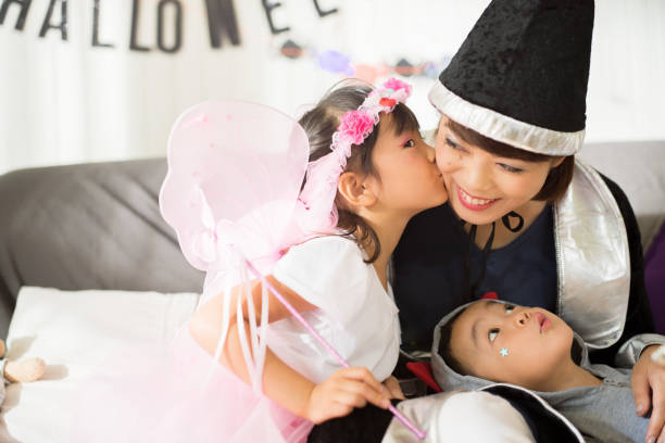 istock Fairy kisses witch at a Halloween party. 843072028