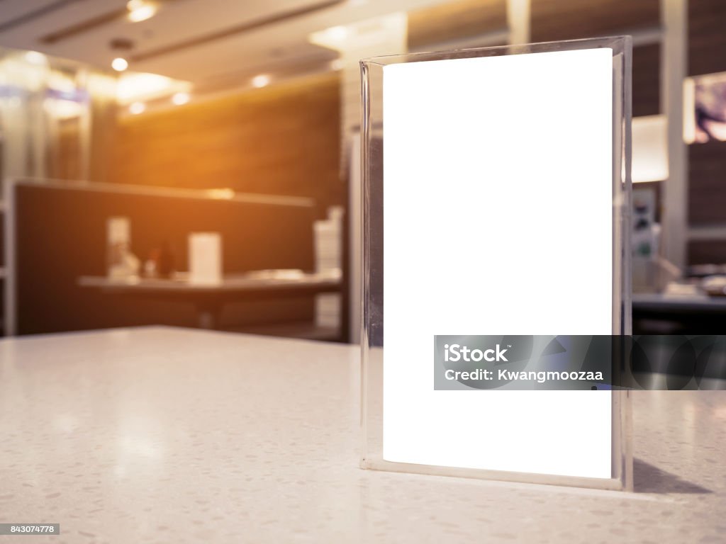 Mock up menu frame on table in the cafe restaurant Mock up menu frame on table in the cafe restaurant, acrylic stand with white paper Playing Card Stock Photo