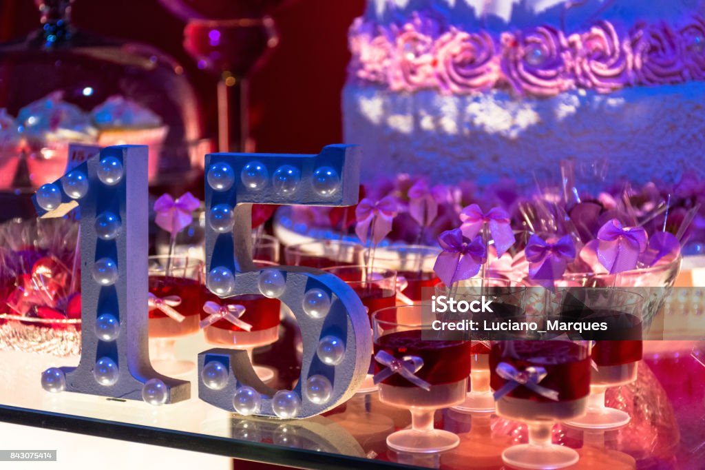 anniversary Party table with 15-year anniversary with Candy and cake with Blur 14-15 Years Stock Photo