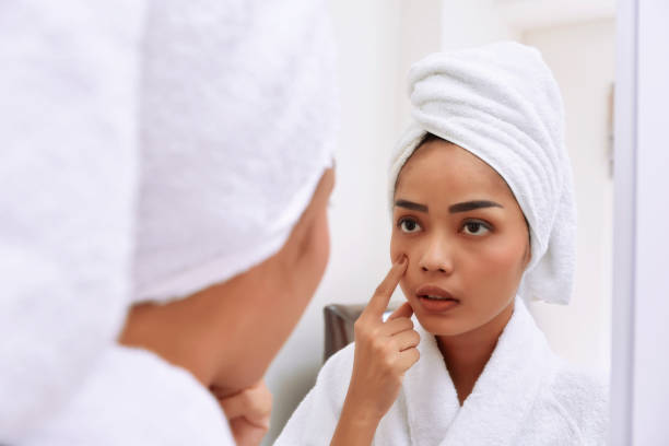 istock Young asian woman with bath towels cleanses her face 843078302