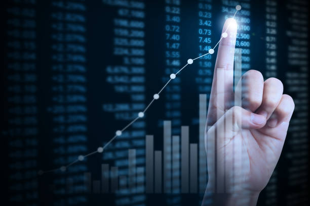 istock businessman with financial chart symbols coming from hand 843083770