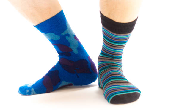 istock Man's Feet in Mismatched Socks, White Background 843084078