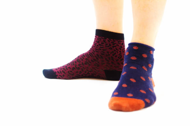 istock Man's Feet in Mismatched Socks, White Background 843084176