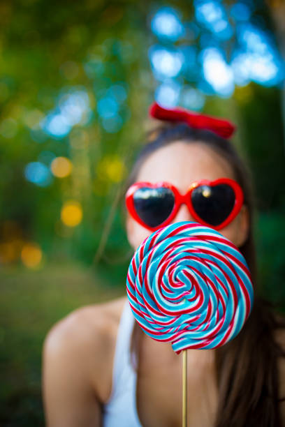 istock Cheerful young girl with candy on stick. 843087080