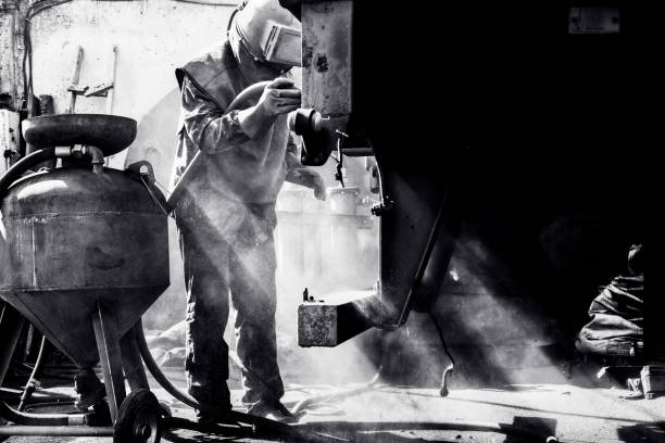 Sandblasting - industrial metal working. Black white photo