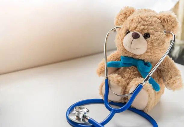 Photo of Children doctor concept - Teddy Bear with stethoscope. copy space