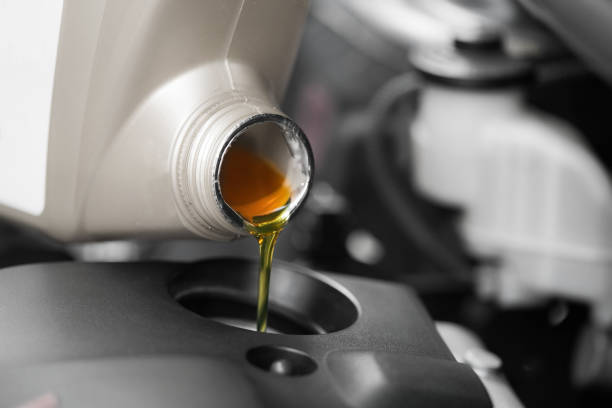 istock Close up, Pouring motor oil to car engine. 843102958