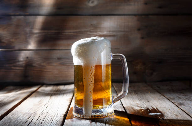 istock mug of beer on wooden background 843106034