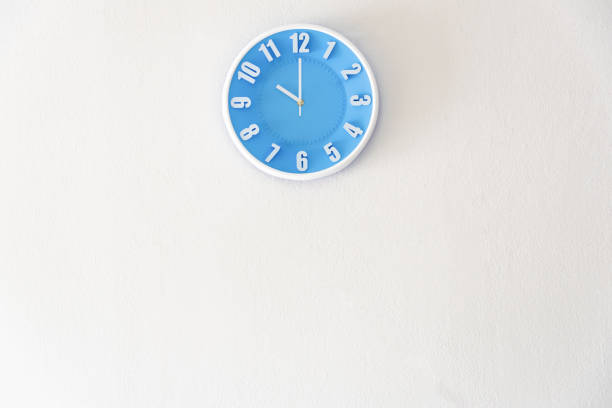 Morning, night or bed time with 10:00 clock on white concrete wall interior background with copy space, message board concept. 10 am is the late time in the morning. 10 pm is the bed time in the night