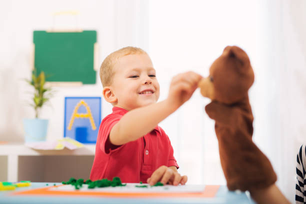 istock Little boy during lesson with his speech therapist. 843114312