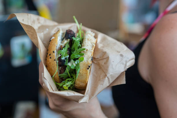 Woman holding juicy burger in her hands.