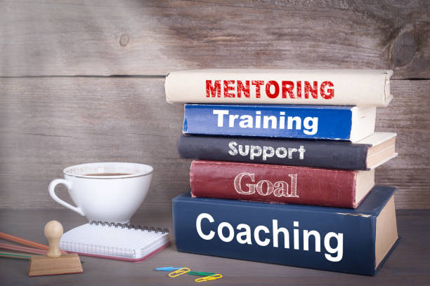 istock Mentoring concept. Stack of books on wooden desk 843119134