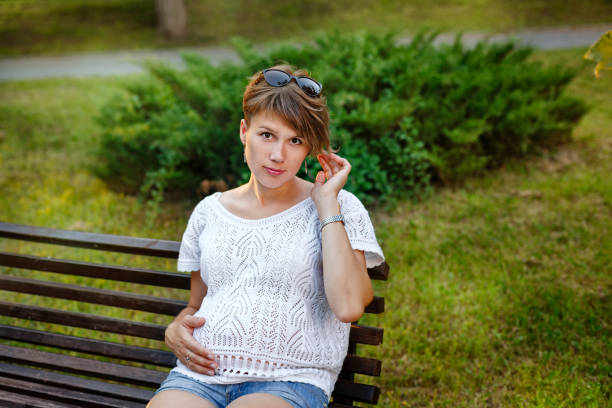 istock Pregnant girl sitting on bench 843123014