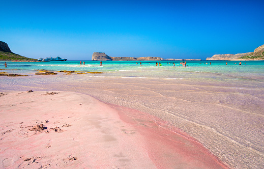 Tropical sandy beach with turquoise water and pink sand, in Elafonisi, Crete