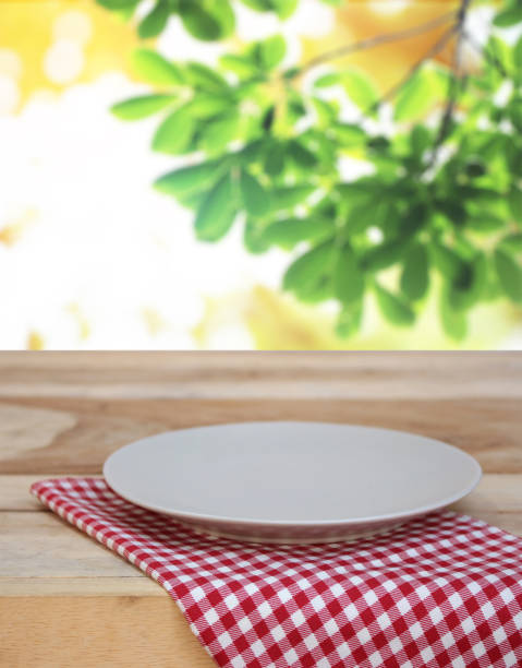 istock dish on checkered tablecloth and blur leaves background 843127508