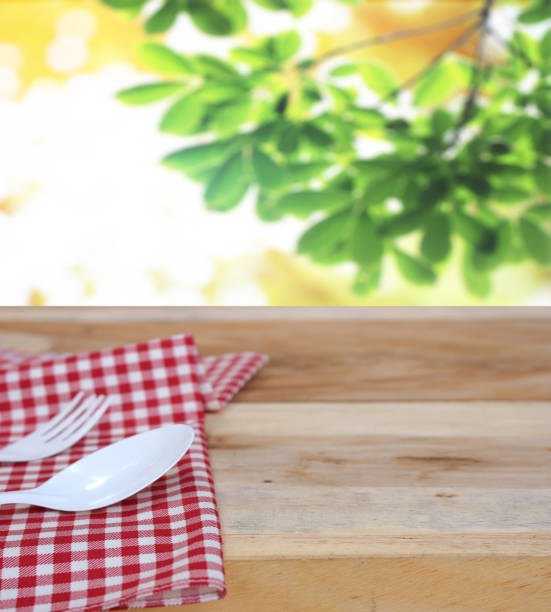 istock spoon with fork on checkered tablecloth and blur leaves background 843127574