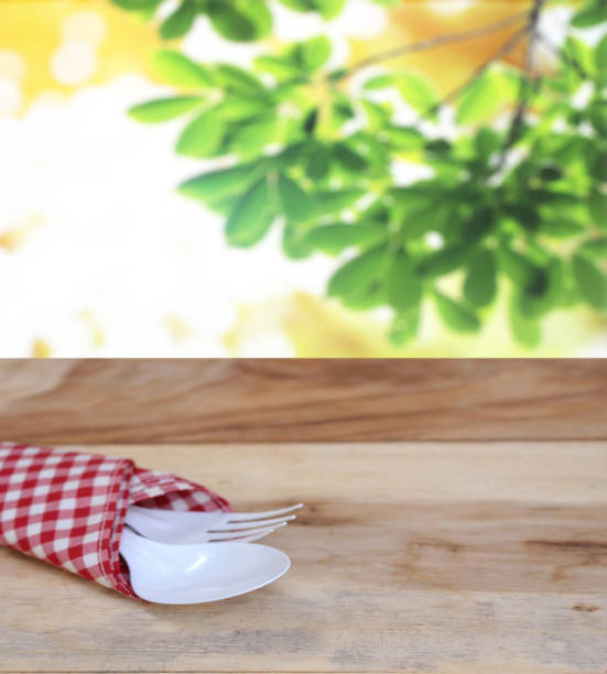 istock spoon with fork on checkered tablecloth and blur leaves background 843127576
