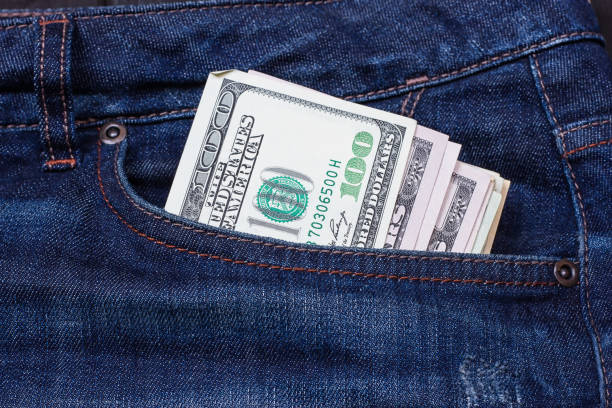 dollars in a pocket of jeans Some dollars in a pocket of jeans american one hundred dollar bill photos stock pictures, royalty-free photos & images