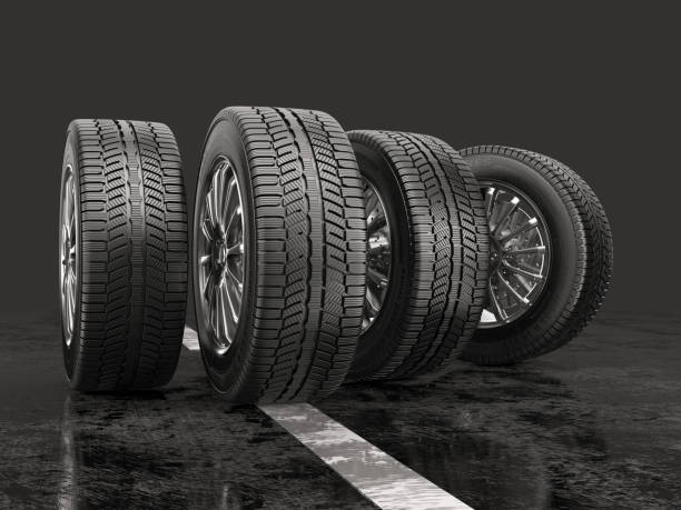 istock Four car tires rolling on a road on a gray background. 843128014