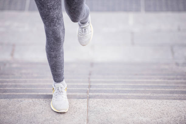 istock Close up female runner foot running up stairs. 843131386