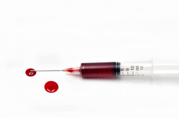 Syringe with blood stock photo